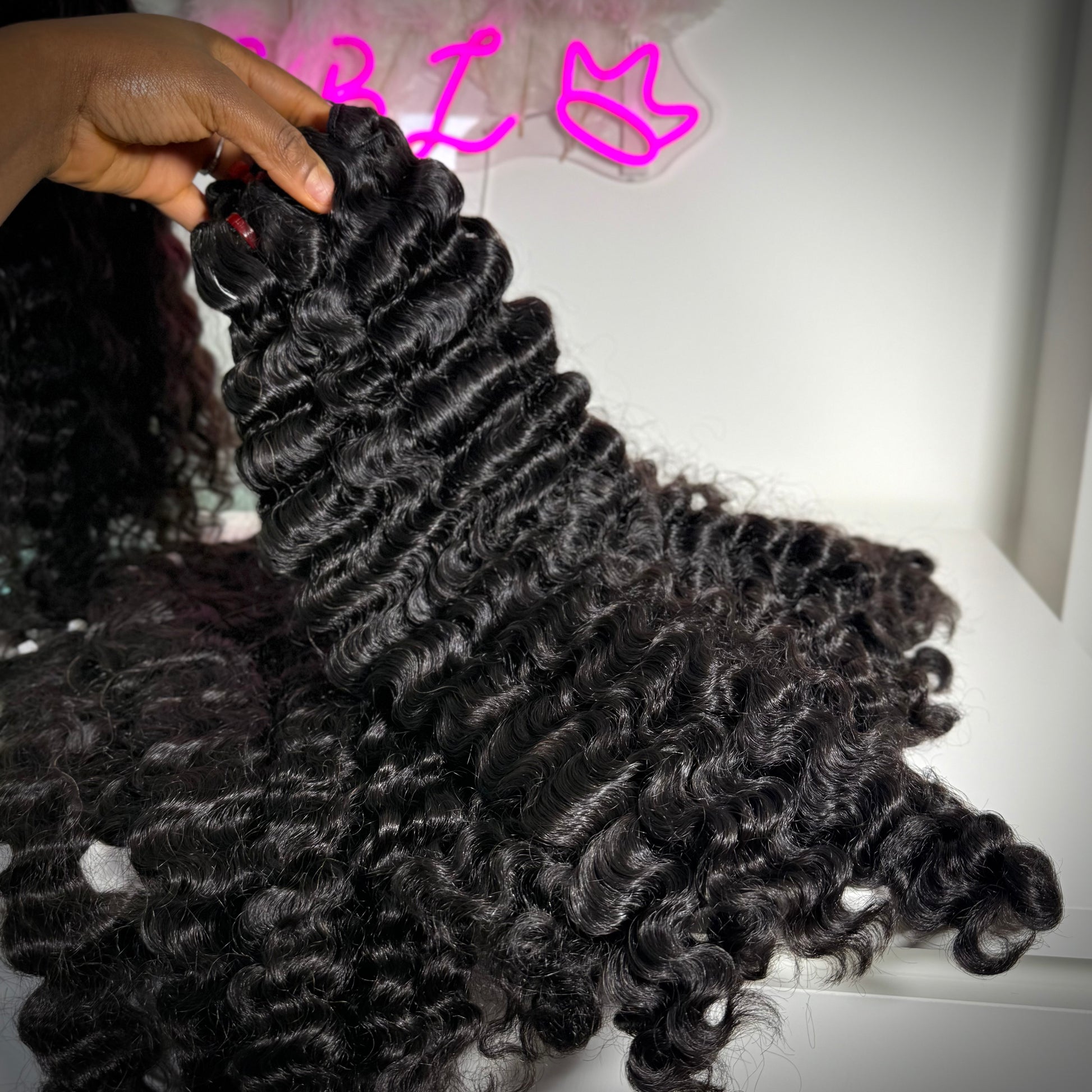 Close-up of Raw Burmese curly hair bundle made with 100% raw human hair extensions for sew-ins, wigs, and protective styles