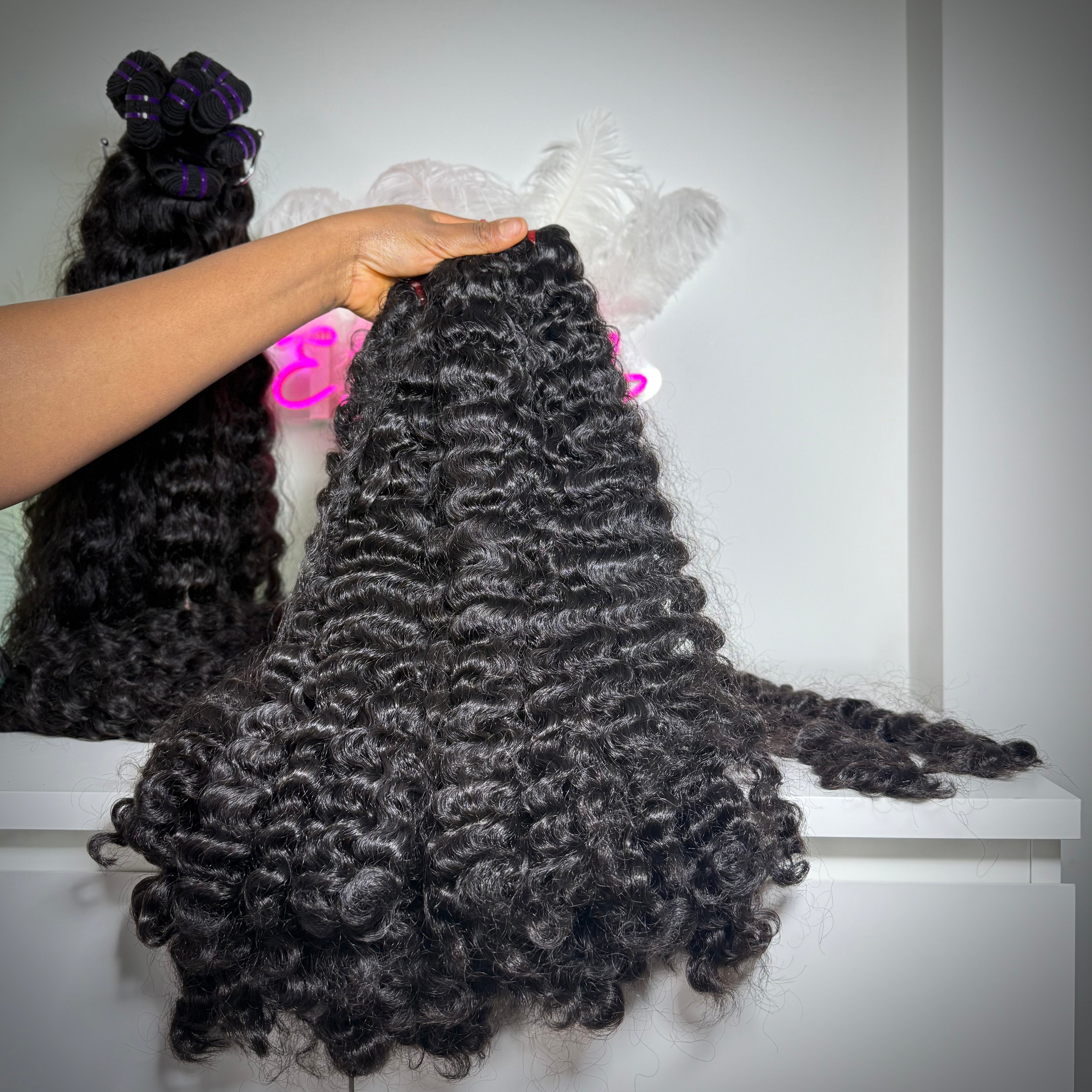 Close-up of Raw Burmese curly hair bundle made with 100% raw human hair extensions for sew-ins, wigs, and protective styles