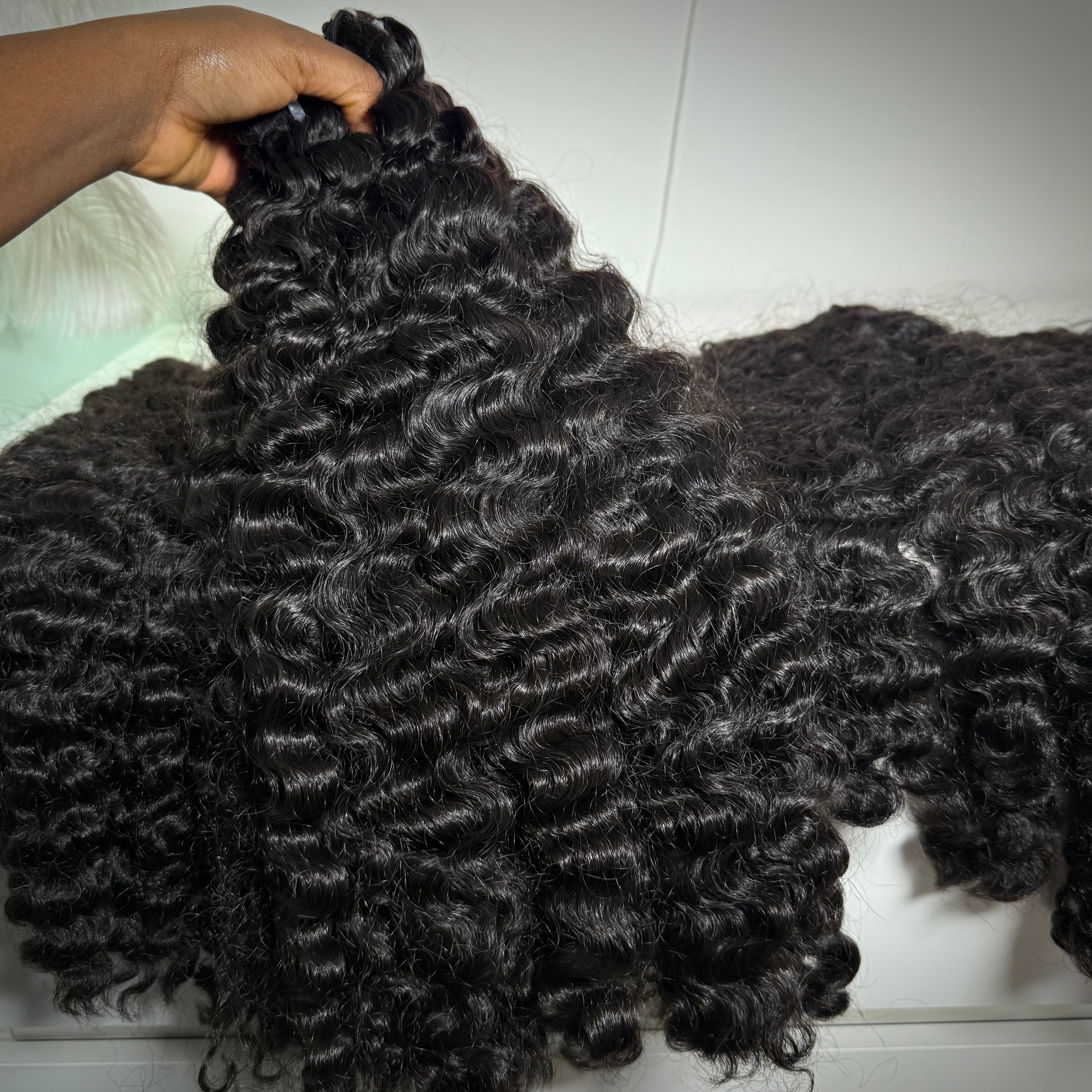 Close-up of Raw Burmese curly hair bundle made with 100% raw human hair extensions for sew-ins, wigs, and protective styles