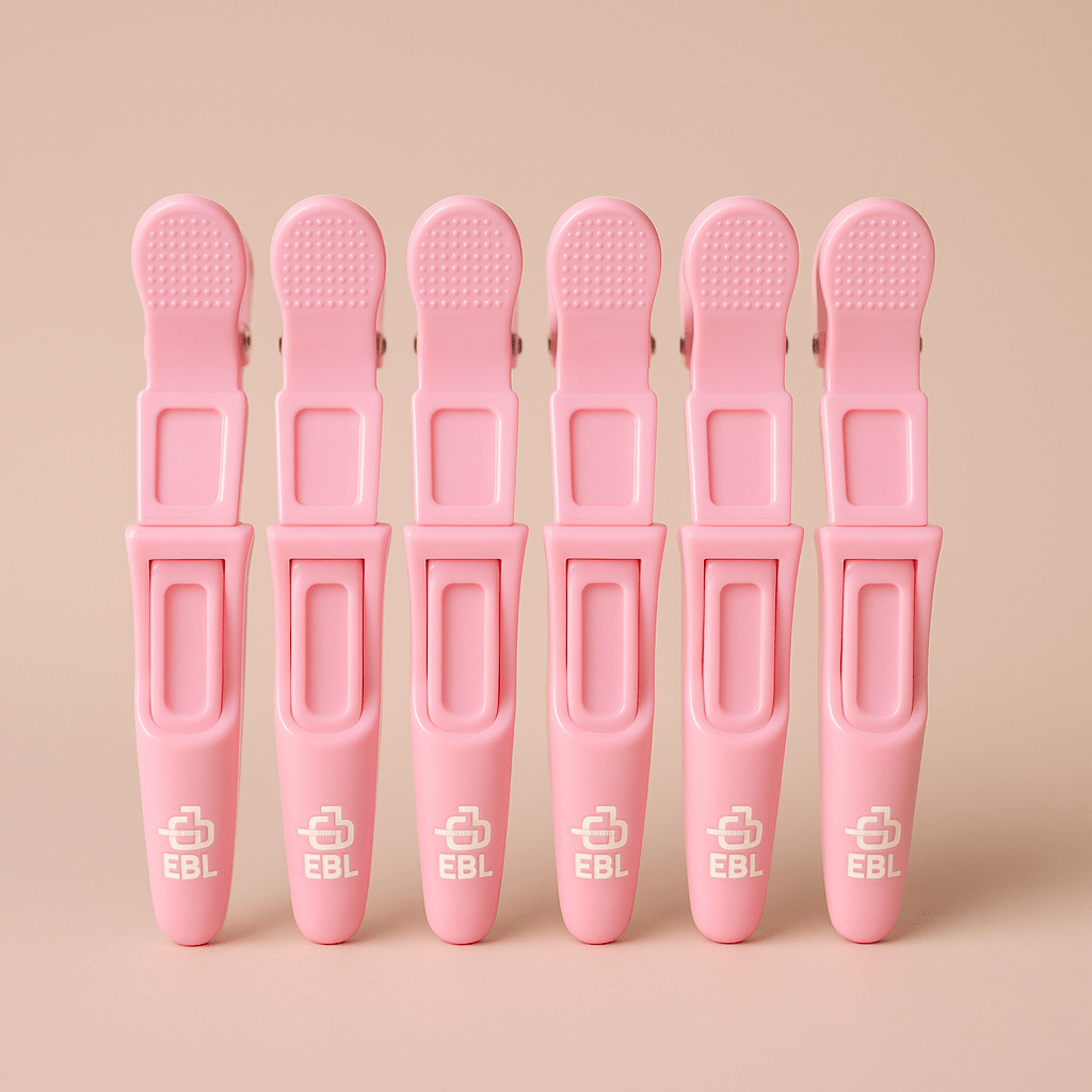 Six pink clips with EBL logo on a beige background