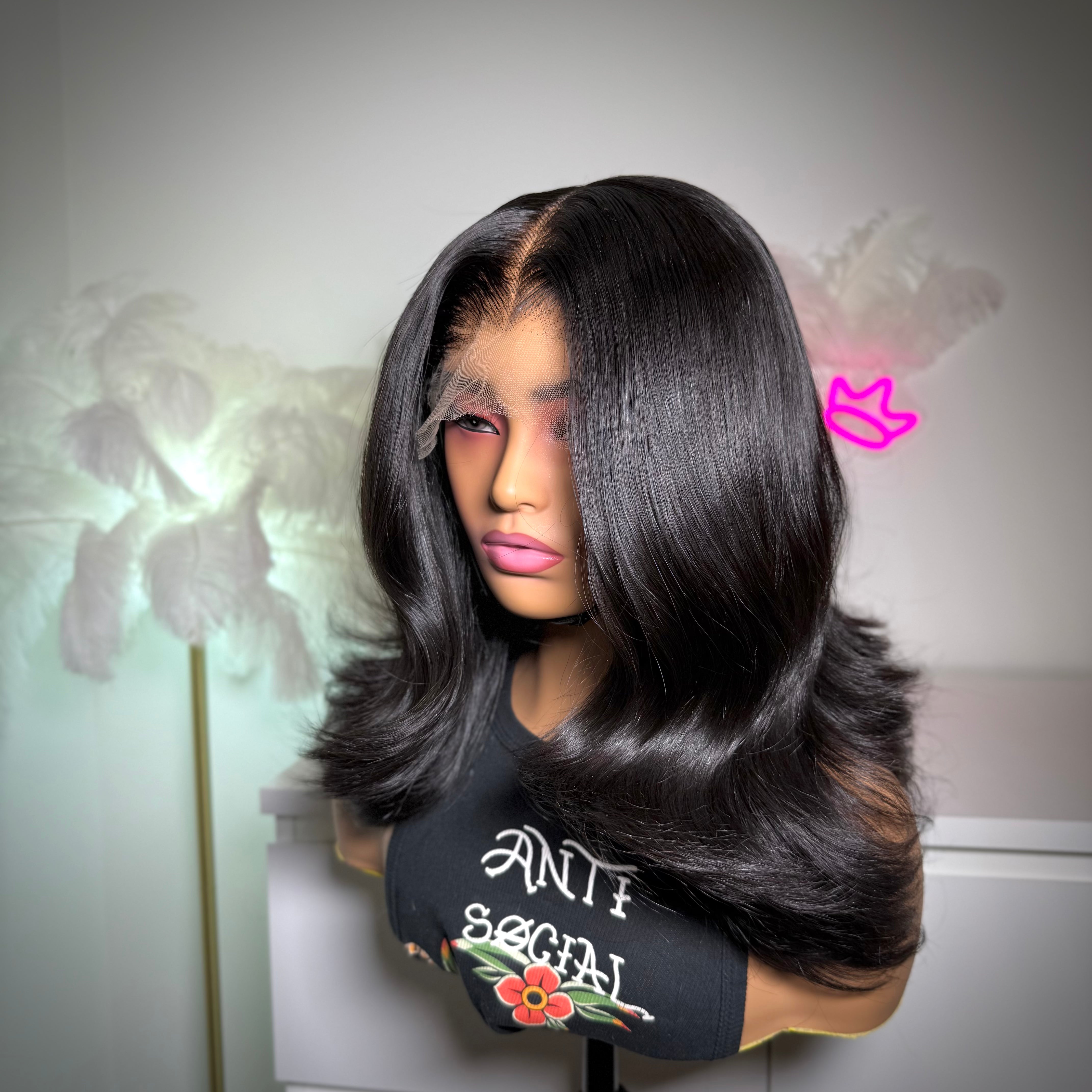 Person wearing a black wig with a blurred background