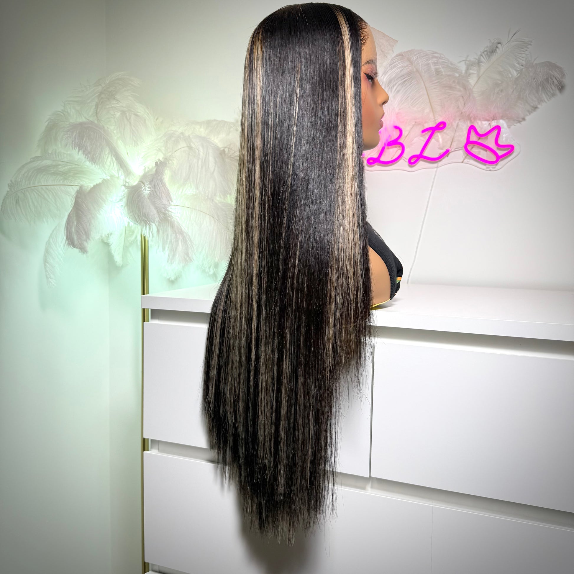 Person with long straight hair styled in a sleek manner against a white background.