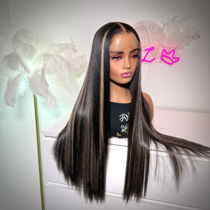 Mannequin head with long black hair against a decorative background