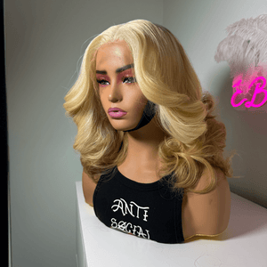 Blonde HD lace wig with body wave curls and soft brown roots